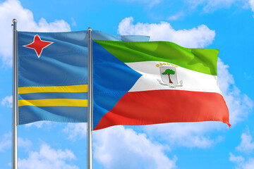 Equatorial Guinea and Aruba national flag waving in the windy deep blue sky. Diplomacy and international relations concept.