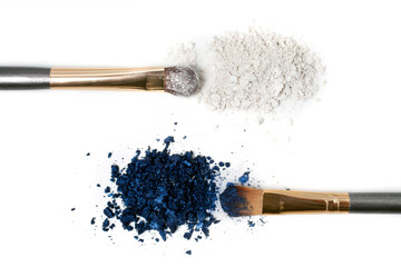 Make-up brushes and powdered cosmetic shadows isolated on a white background. Top view. 