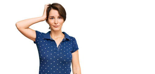 Young brunette woman with short hair wearing casual clothes confuse and wonder about question. uncertain with doubt, thinking with hand on head. pensive concept.