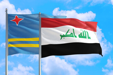Iraq and Aruba national flag waving in the windy deep blue sky. Diplomacy and international relations concept.