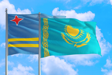 Kazakhstan and Aruba national flag waving in the windy deep blue sky. Diplomacy and international relations concept.