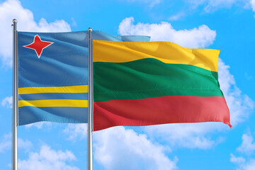 Lithuania and Aruba national flag waving in the windy deep blue sky. Diplomacy and international relations concept.
