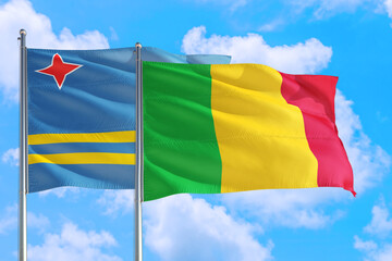 Mali and Aruba national flag waving in the windy deep blue sky. Diplomacy and international relations concept.