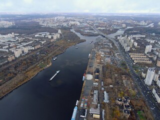 Fototapeta premium Aerial view panoramic cityscape with great height. River in a big city from a drone
