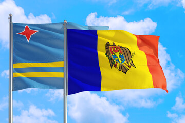 Moldova and Aruba national flag waving in the windy deep blue sky. Diplomacy and international relations concept.