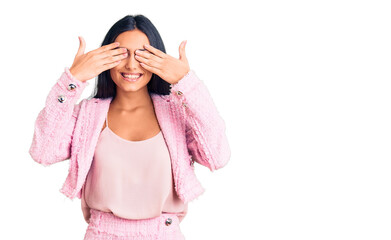 Young beautiful latin girl wearing business clothes covering eyes with hands smiling cheerful and funny. blind concept.