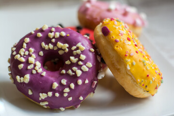 Stacked Glazed Donuts.
 A Pile Of Colorful Donuts.