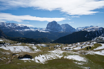 Naklejka na ściany i meble Beautiful langkofel mountain in the dolomites seen from the seceda alm with the first snow white and blue sky
