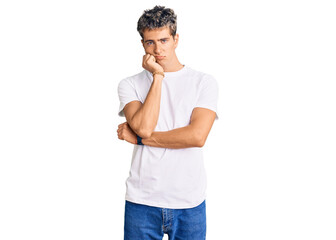 Young handsome man wearing casual white tshirt thinking looking tired and bored with depression...