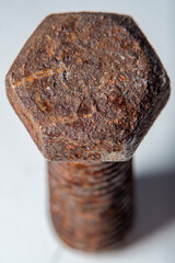 Close-up of a part of an old metal screw covered with rust with fine details clearly visible