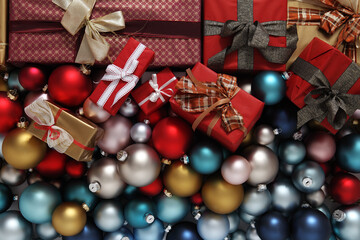 merry christmas, top view of wrapped gift present packages and colored balls decorations, useful as a greeting gift card background