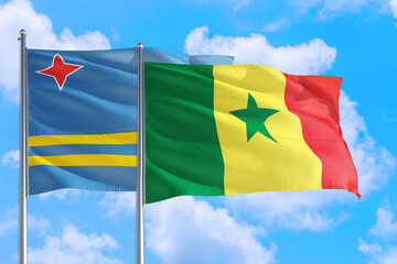 Senegal and Aruba national flag waving in the windy deep blue sky. Diplomacy and international relations concept.Scotland