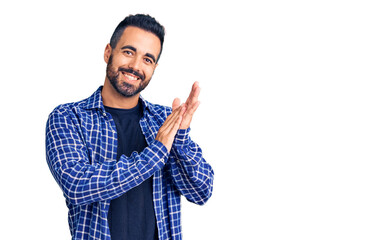 Young hispanic man wearing casual clothes clapping and applauding happy and joyful, smiling proud...