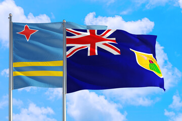 Turks And Caicos Islands and Aruba national flag waving in the windy deep blue sky. Diplomacy and international relations concept.