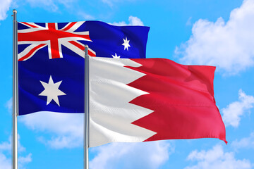 Bahrain and Australia national flag waving in the windy deep blue sky. Diplomacy and international relations concept.