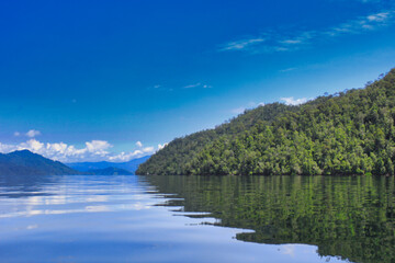 Fototapeta na wymiar Island with Blue Sky Background