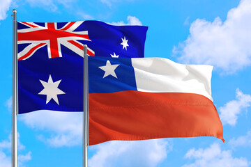 Chile and Australia national flag waving in the windy deep blue sky. Diplomacy and international relations concept.
