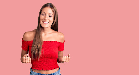 Young beautiful hispanic woman wearing casual clothes very happy and excited doing winner gesture with arms raised, smiling and screaming for success. celebration concept.