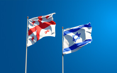 Beautiful national state flags of Georgia and Israel together at the sky background. 3D artwork concept.