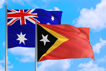 East Timor and Australia national flag waving in the windy deep blue sky. Diplomacy and international relations concept.