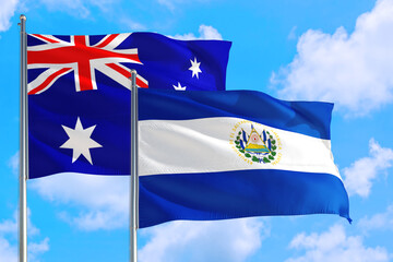 El Salvador and Australia national flag waving in the windy deep blue sky. Diplomacy and international relations concept.