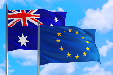 European Union and Australia national flag waving in the windy deep blue sky. Diplomacy and international relations concept.