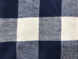 Plaid check patten in dark navy, blue and white. Fabric texture.