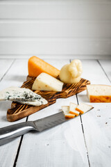 Various types of cheese. On a white wooden background. Dor Blue, parmesan, Cachocavallo. Homemade cheese production. copy space