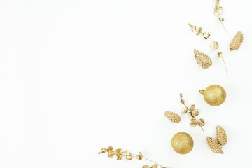 Christmas winter composition. Golden decoration on white background. Flat lay, top view. New Year
