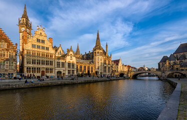 Fototapeta na wymiar View of Graslei, Korenlei quays and Leie river in the historic city center in Ghent (Gent), Belgium. Architecture and landmark of Ghent. Sunset cityscape of Ghent.