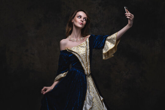 Beautiful Woman In Renaissance Dress Taking Selfie On Smartphone, Old And New Concept