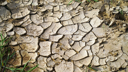 Close up view of cracked dried soil. Desiccation in soil, hard panic surface, natural dryness and rough desert plains. It occurs naturally Laterite soil.
