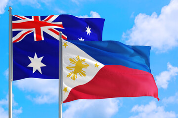 Philippines and Australia national flag waving in the windy deep blue sky. Diplomacy and international relations concept.