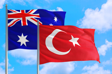 Turkey and Australia national flag waving in the windy deep blue sky. Diplomacy and international relations concept.