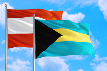 Bahamas and Austria national flag waving in the windy deep blue sky. Diplomacy and international relations concept.