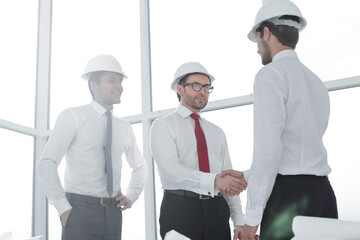 Architect and the engineering contractor shaking hands
