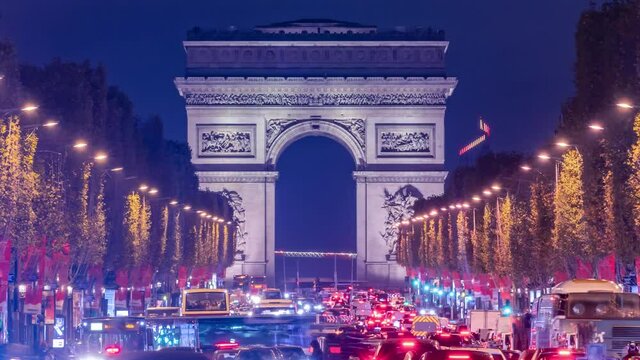 4K Timelapse of traffic at Arc de Triomph at night in an autumn winter day. This historical monument overlooks the avenue des champs &eacute;lys&eacute;es in the heart of Paris, French capital. 