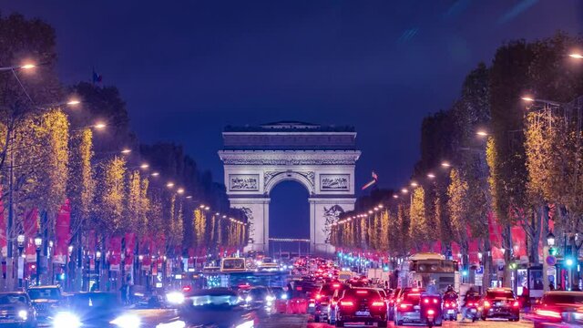 4K Timelapse of traffic at Arc de Triomph at night in an autumn winter day. This historical monument overlooks the avenue des champs &eacute;lys&eacute;es in the heart of Paris, French capital. 