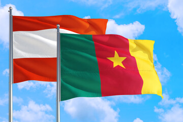 Cameroon and Austria national flag waving in the windy deep blue sky. Diplomacy and international relations concept.