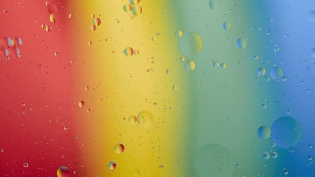Mixing liquids of different density against the background of iridescent light