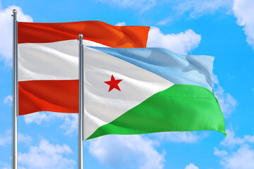 Djibouti and Austria national flag waving in the windy deep blue sky. Diplomacy and international relations concept.