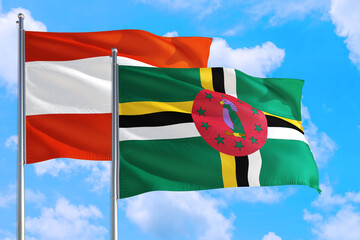 Dominica and Austria national flag waving in the windy deep blue sky. Diplomacy and international relations concept.