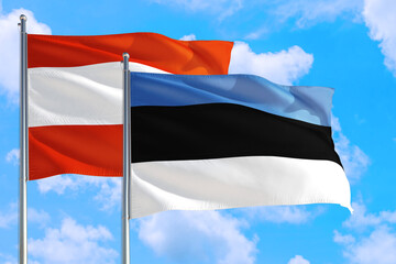 Estonia and Austria national flag waving in the windy deep blue sky. Diplomacy and international relations concept.