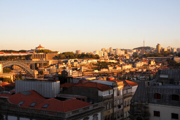 Fototapeta na wymiar View from the hill on Porto in Portugal. Red roofs of buildings at sunset
