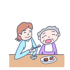 高齢者に食事の介助をしている女性