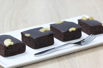 Chocolate brownie squares on white background