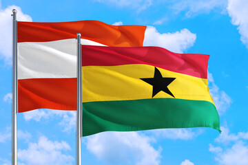 Ghana and Austria national flag waving in the windy deep blue sky. Diplomacy and international relations concept.