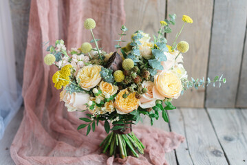 Yellow flowers with blackberry roses camomile greens on wooden background. Wedding Details, Bridesmaid Bouquet