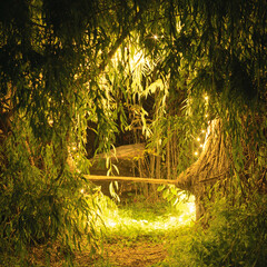 Bench among willows lighted by led lights © EvhKorn