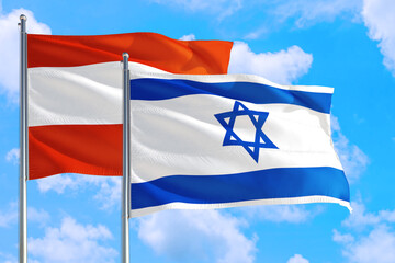 Israel and Austria national flag waving in the windy deep blue sky. Diplomacy and international relations concept.